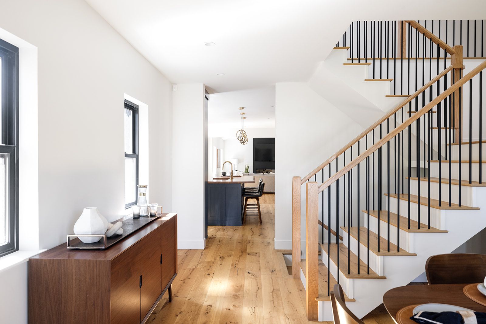 A hallway with stairs leading up to the second floor of a house.