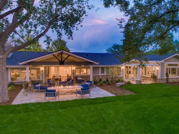 A large house with a fire pit in the backyard.