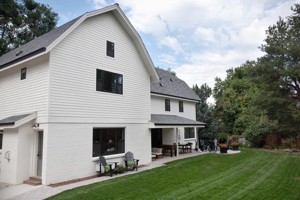 A white house with a large lawn in front of it