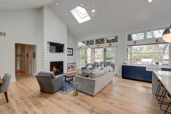 A living room with a couch, chairs, and a fireplace.