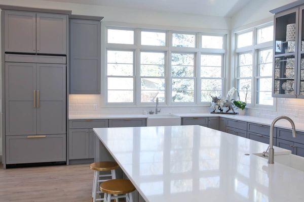 A large kitchen with a table and chairs in it.
