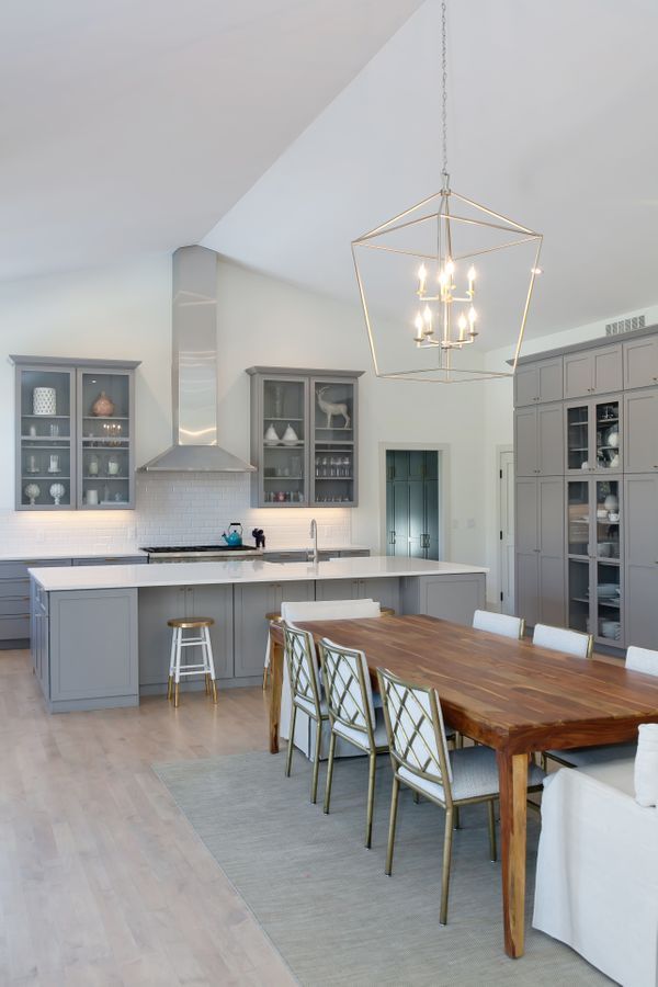 A kitchen with a large wooden table and chairs.