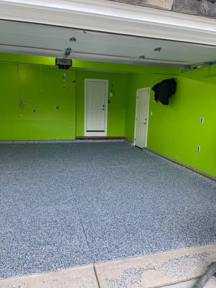 Empty lime-green garage with gray carpet and two white doors