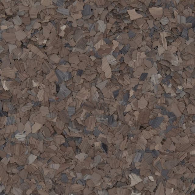 A close-up of brown and gray gravel or wood chips forming a textured surface.