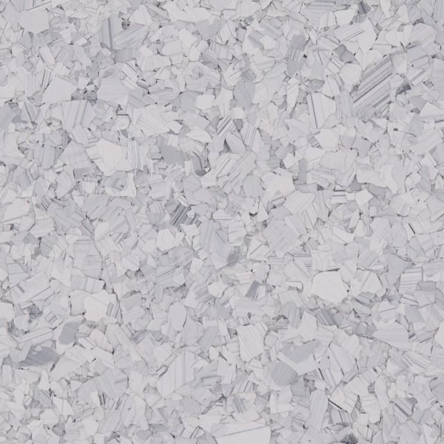 Close-up of white shredded paper confetti scattered across a light gray surface
