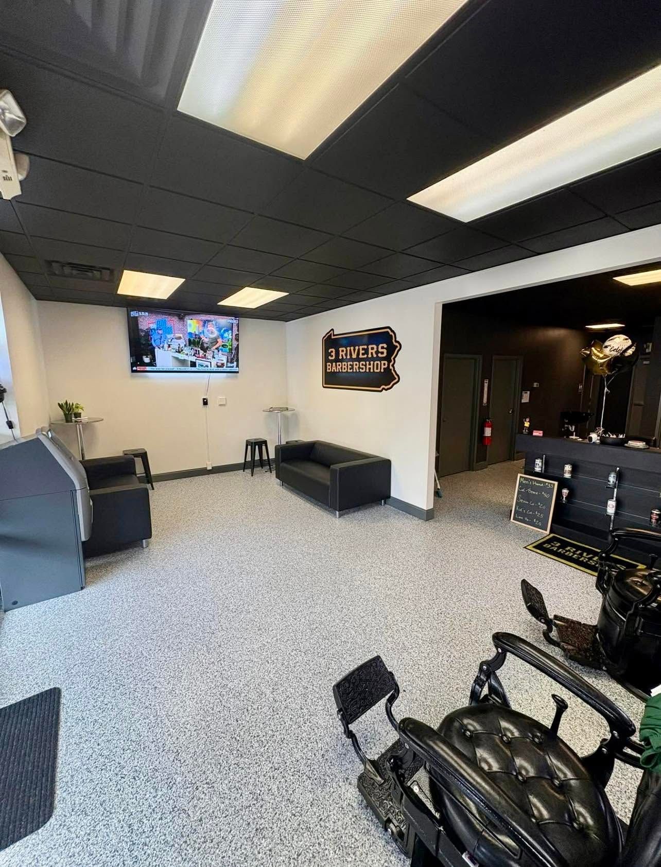 Quiet indoor waiting area with wall TV, bench seating, and bikes in the foreground