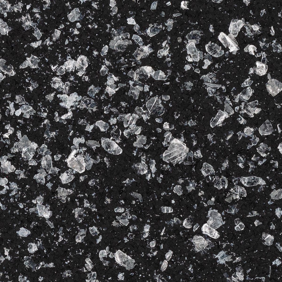 Close-up of dark asphalt with scattered white gravel specks
