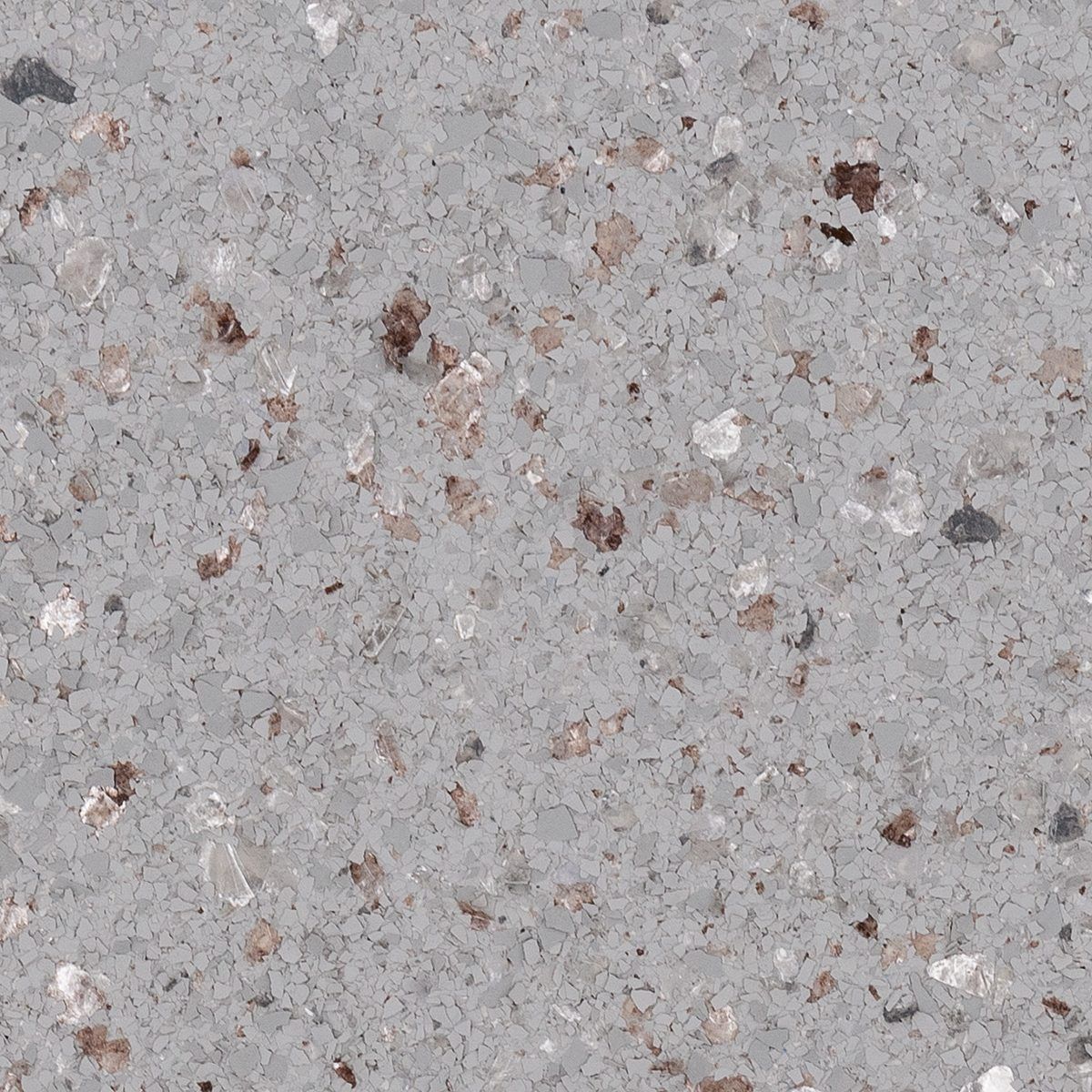 Close-up of light gray speckled concrete surface with small brown and white flecks