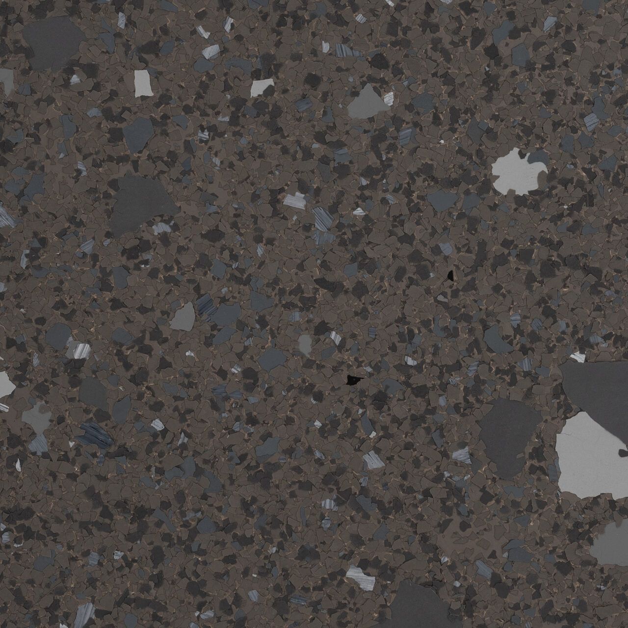 Close-up of a dark speckled stone or granite surface with white and gray flecks