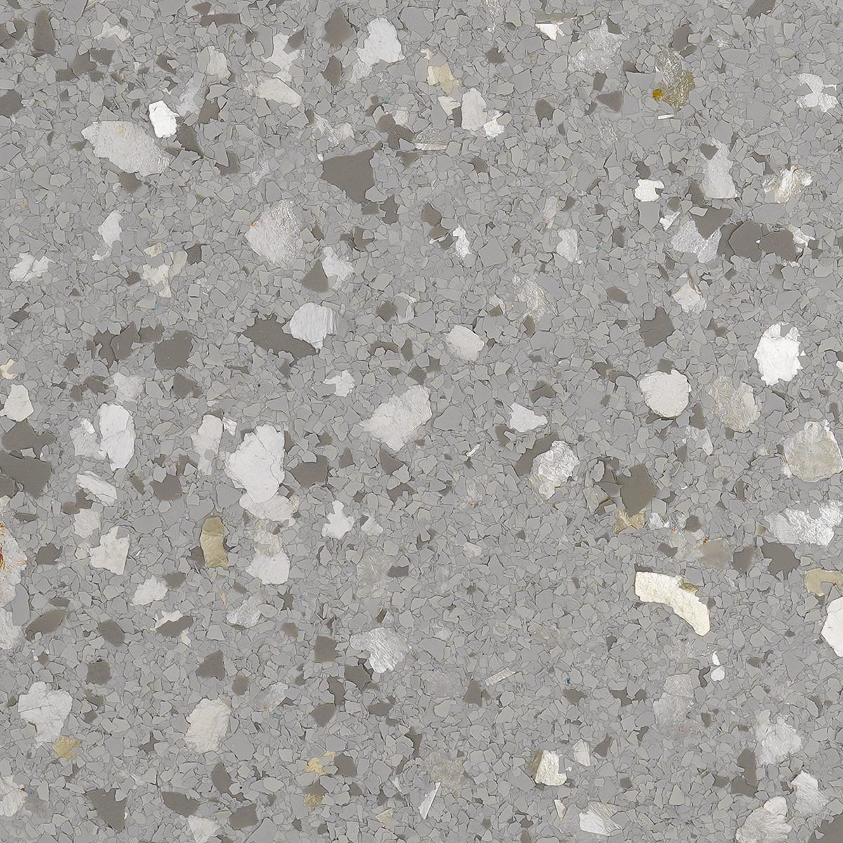 Close-up of gray speckled stone or concrete surface with white and beige flecks