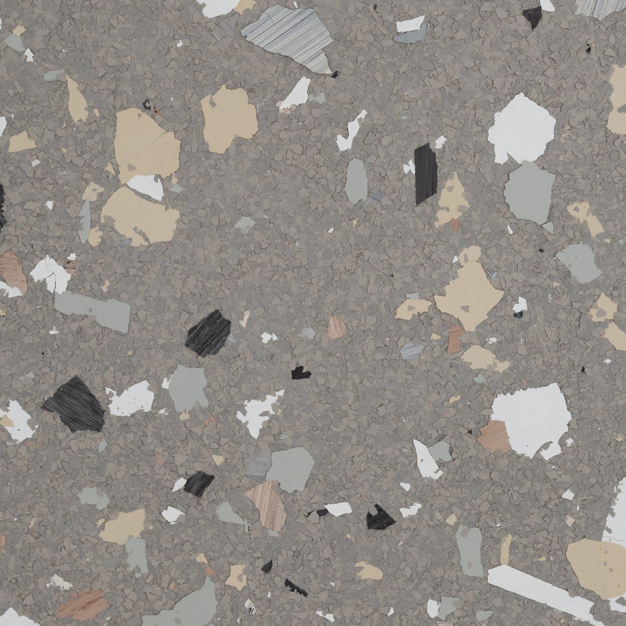 Close-up of gray terrazzo flooring with scattered white, beige, and black stone chips