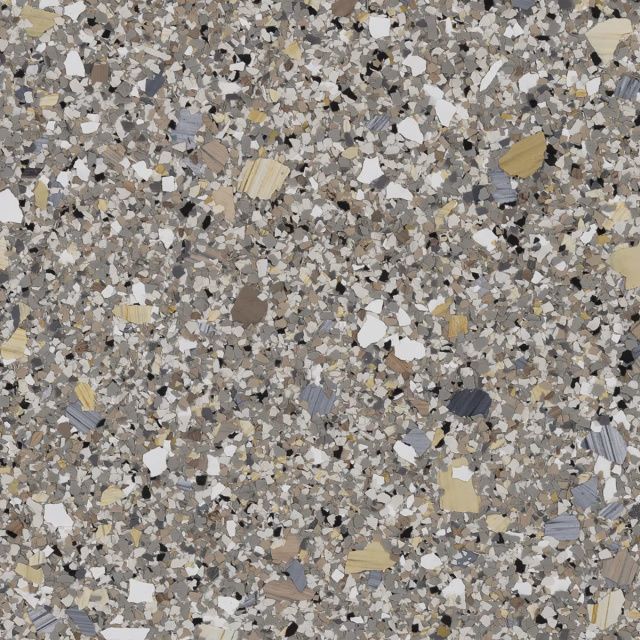 Close-up of gray terrazzo flooring with scattered beige and black stone chips
