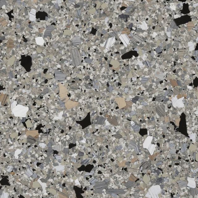 Close-up of gray speckled stone or concrete surface with black and white flecks