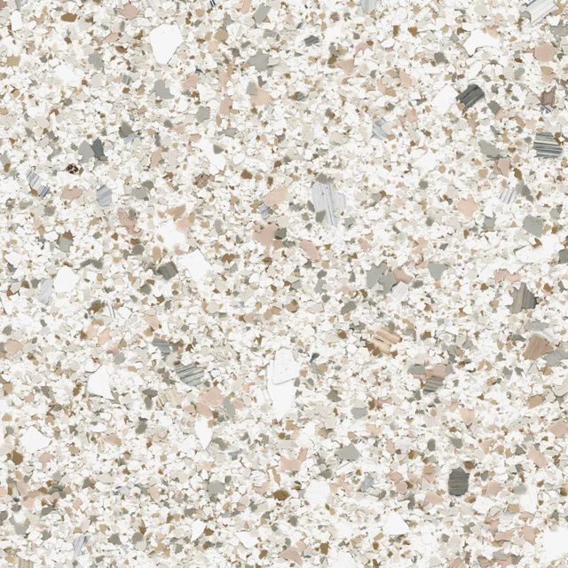 Close-up of a light beige speckled stone or terrazzo surface
