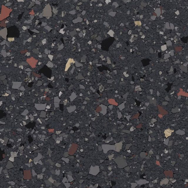 Close-up of dark speckled terrazzo with scattered gray, black, red, and beige chips