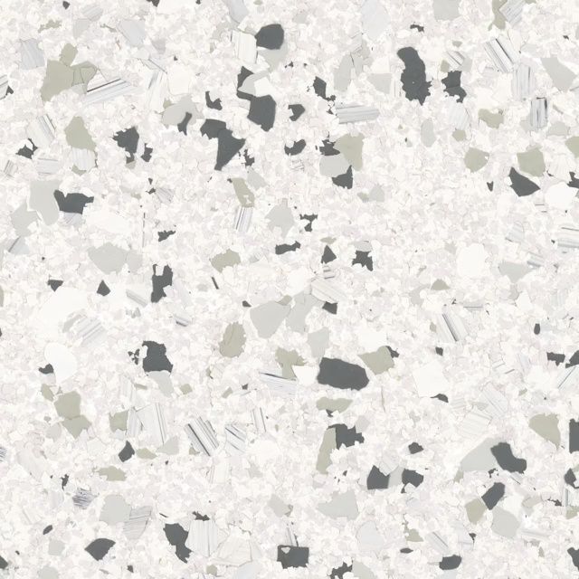 White terrazzo-like surface with scattered gray and black speckles
