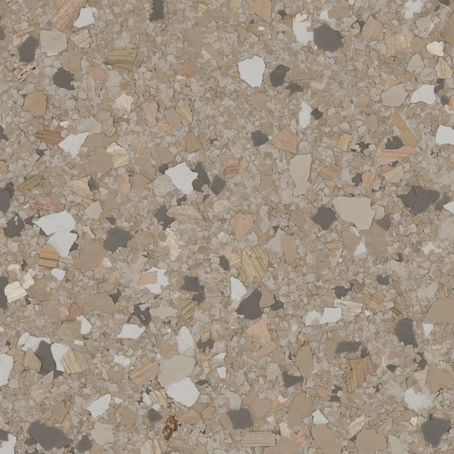 Close-up of a speckled beige terrazzo surface with white, brown, and gray chips.
