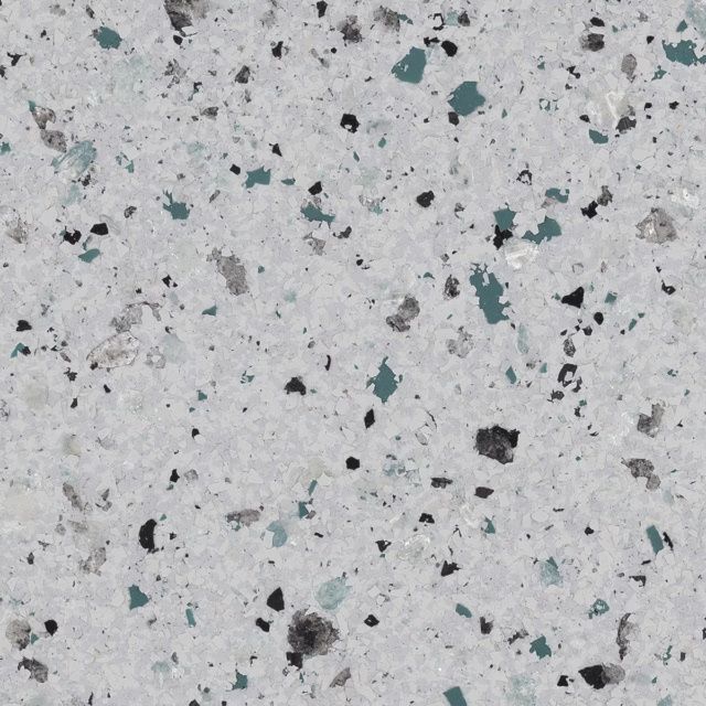 Speckled light gray concrete surface with scattered black and teal flecks