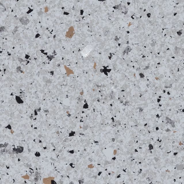 Close-up of light gray speckled stone or terrazzo surface with black and tan flecks
