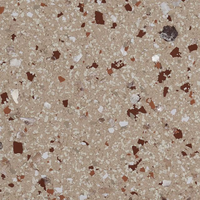 Close-up of speckled beige terrazzo flooring with white, brown, and rust-colored chips