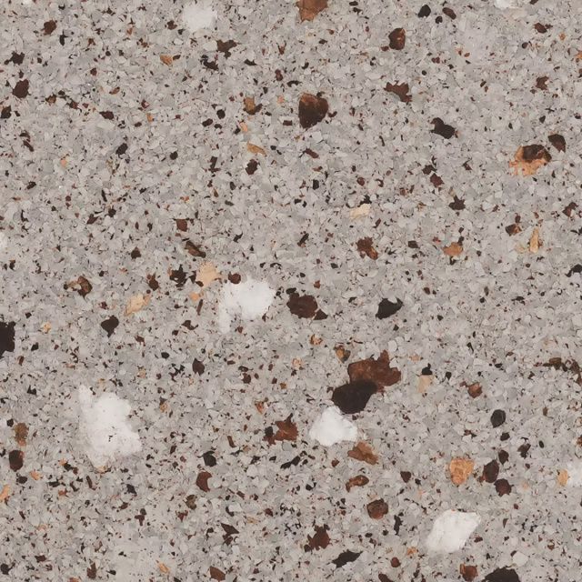 Close-up of speckled gray stone or concrete with white and brown flecks