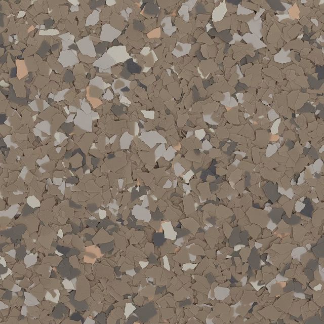 Close-up of a speckled brown and beige terrazzo-like surface with scattered stone chips.