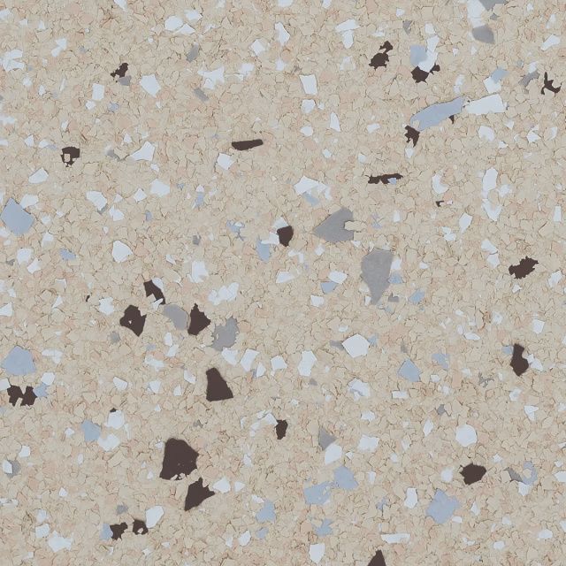Close-up of beige terrazzo flooring with white, gray, and dark stone chips