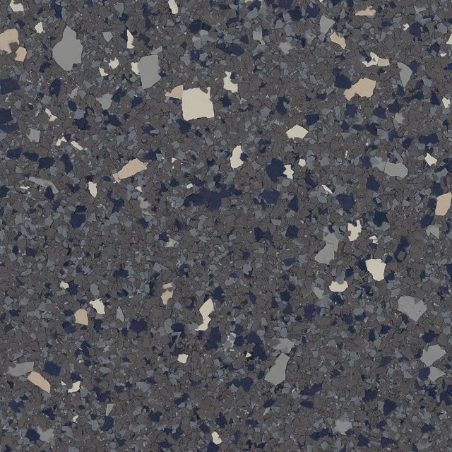 Close-up of dark speckled stone or terrazzo surface with gray, blue, and beige flecks