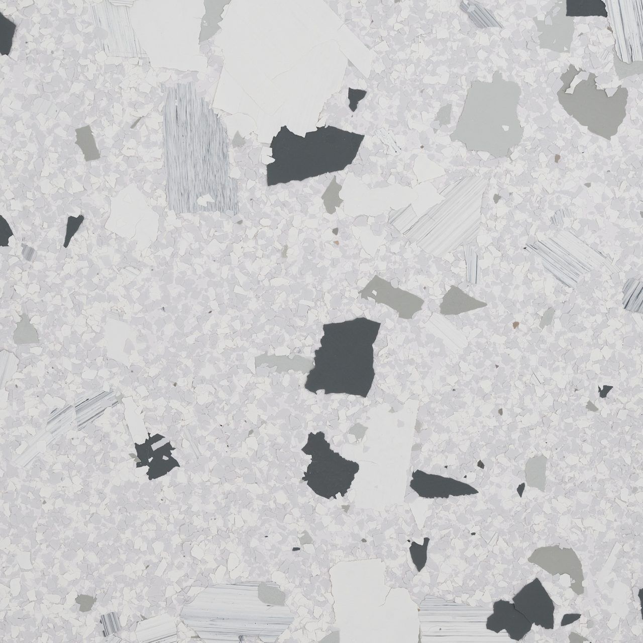 Light gray speckled stone or concrete surface with scattered dark patches