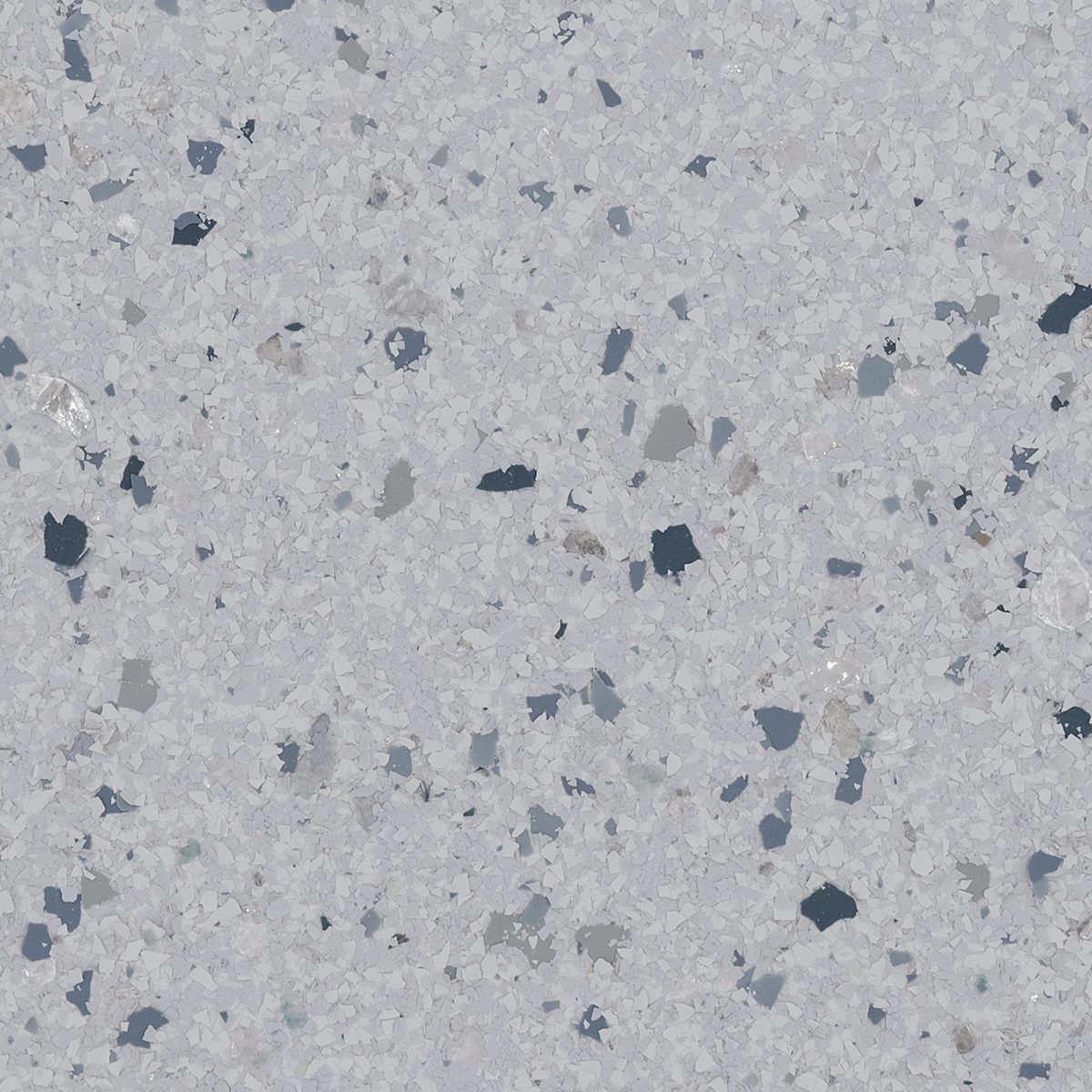 Close-up of light gray speckled concrete surface with scattered dark aggregate chips