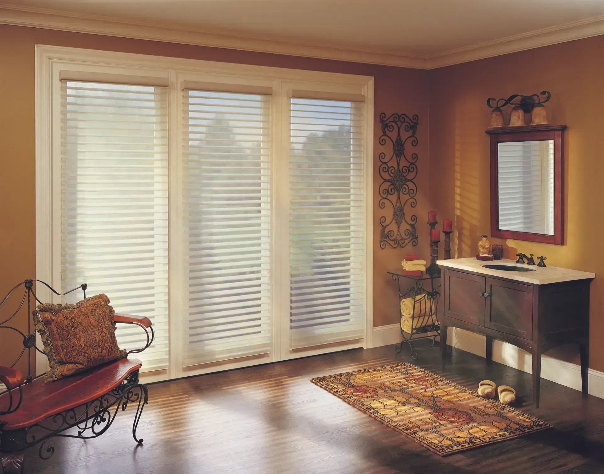 Room with window blinds, a chair, and a vanity. Warm colors, natural light.