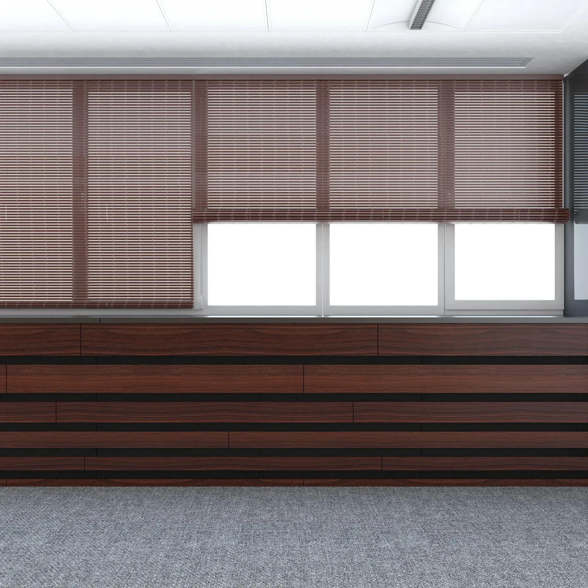 Brown blinds over three windows with a wooden cabinet underneath, and grey carpet.