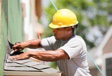 Contractor installing shingle
