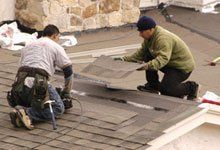 Two contractors installing shingle roof