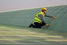 Contractor repairing metal roof