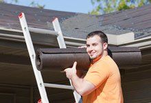 Roofing contractor carrying shingles