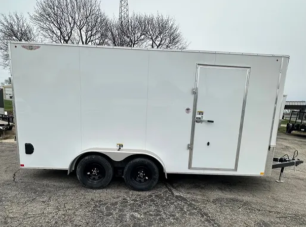 White enclosed cargo trailer with black wheels and a side door.