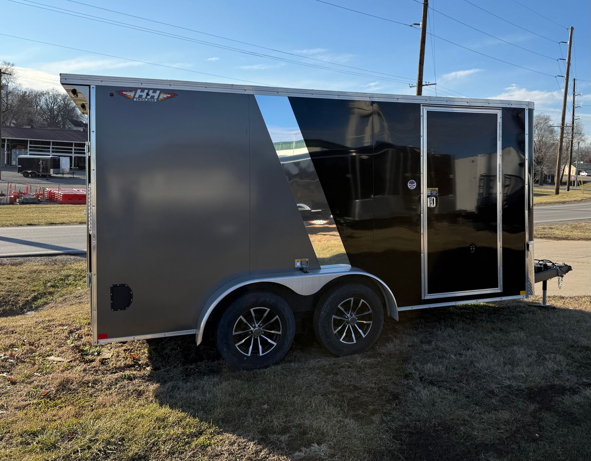 Black and gray enclosed trailer with dual wheels