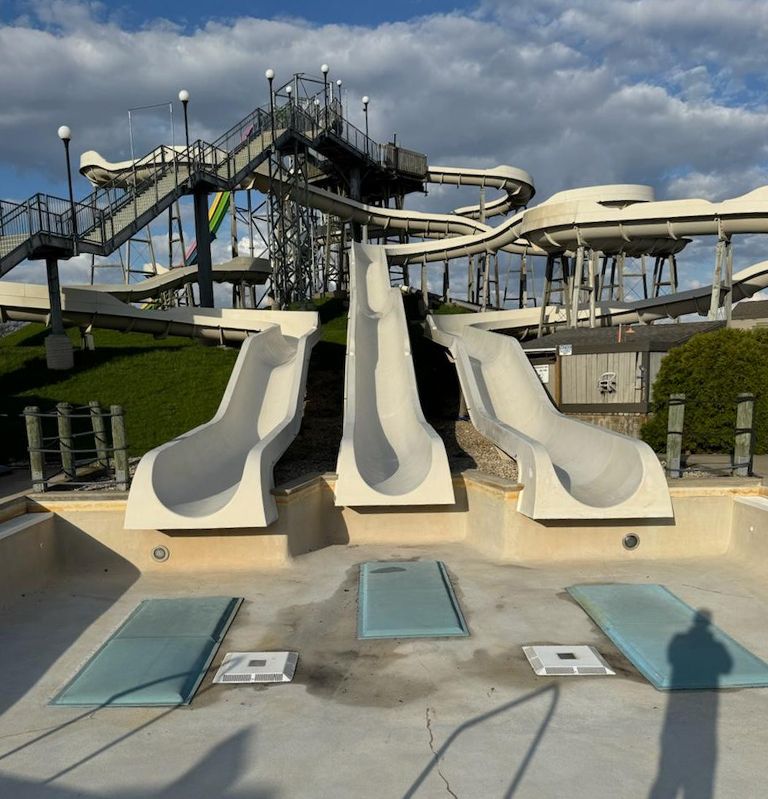 A water park with a lot of slides and stairs