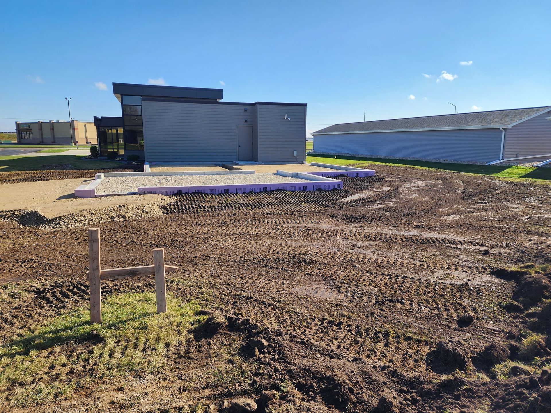 A house is being built in the middle of a dirt field.