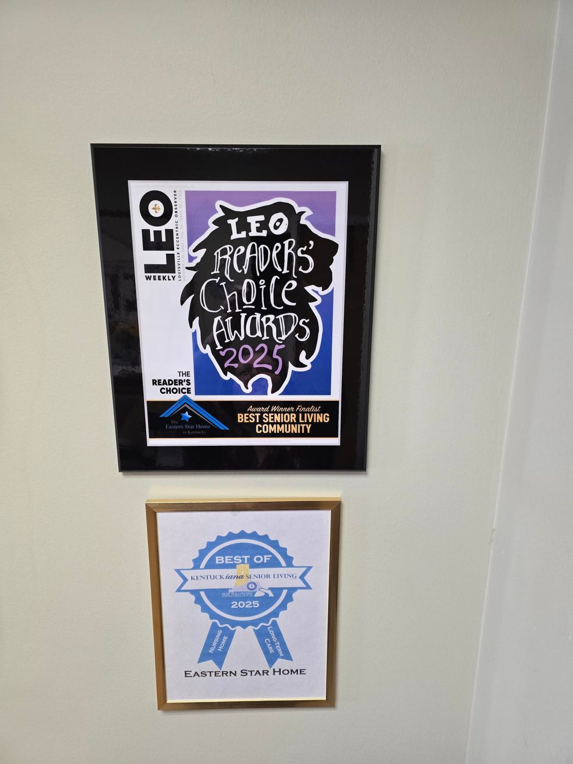 Two framed awards on a wall: LEO Readers' Choice 2023, and Best of Louisville.