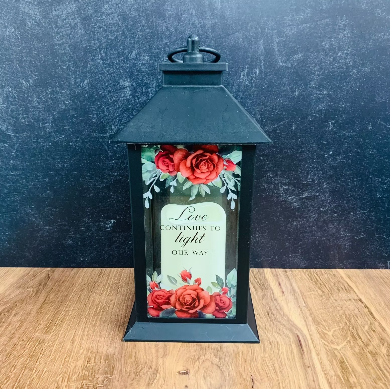 Black lantern with roses and the text