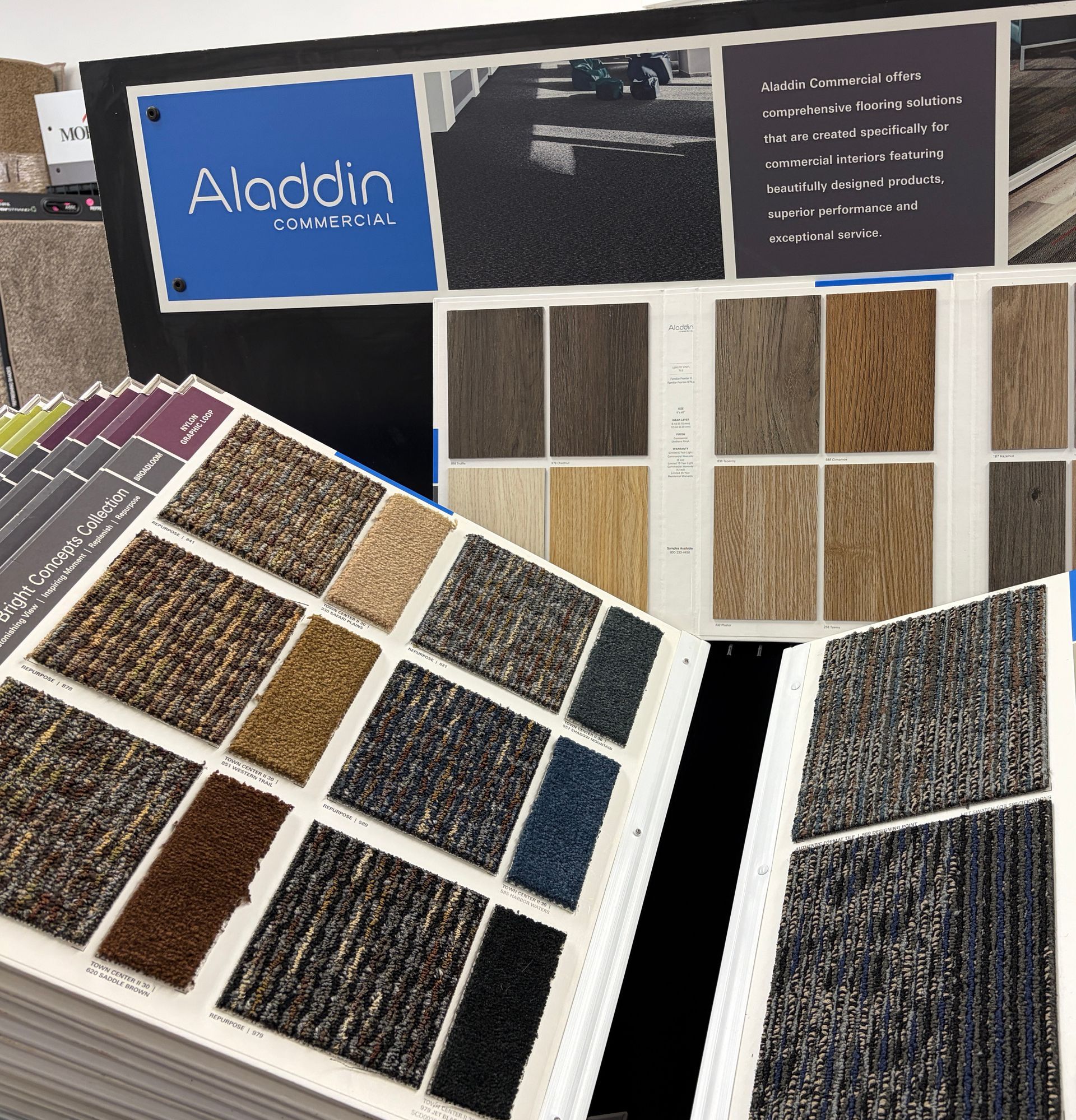 Carpet samples in various colors and textures displayed in a store.