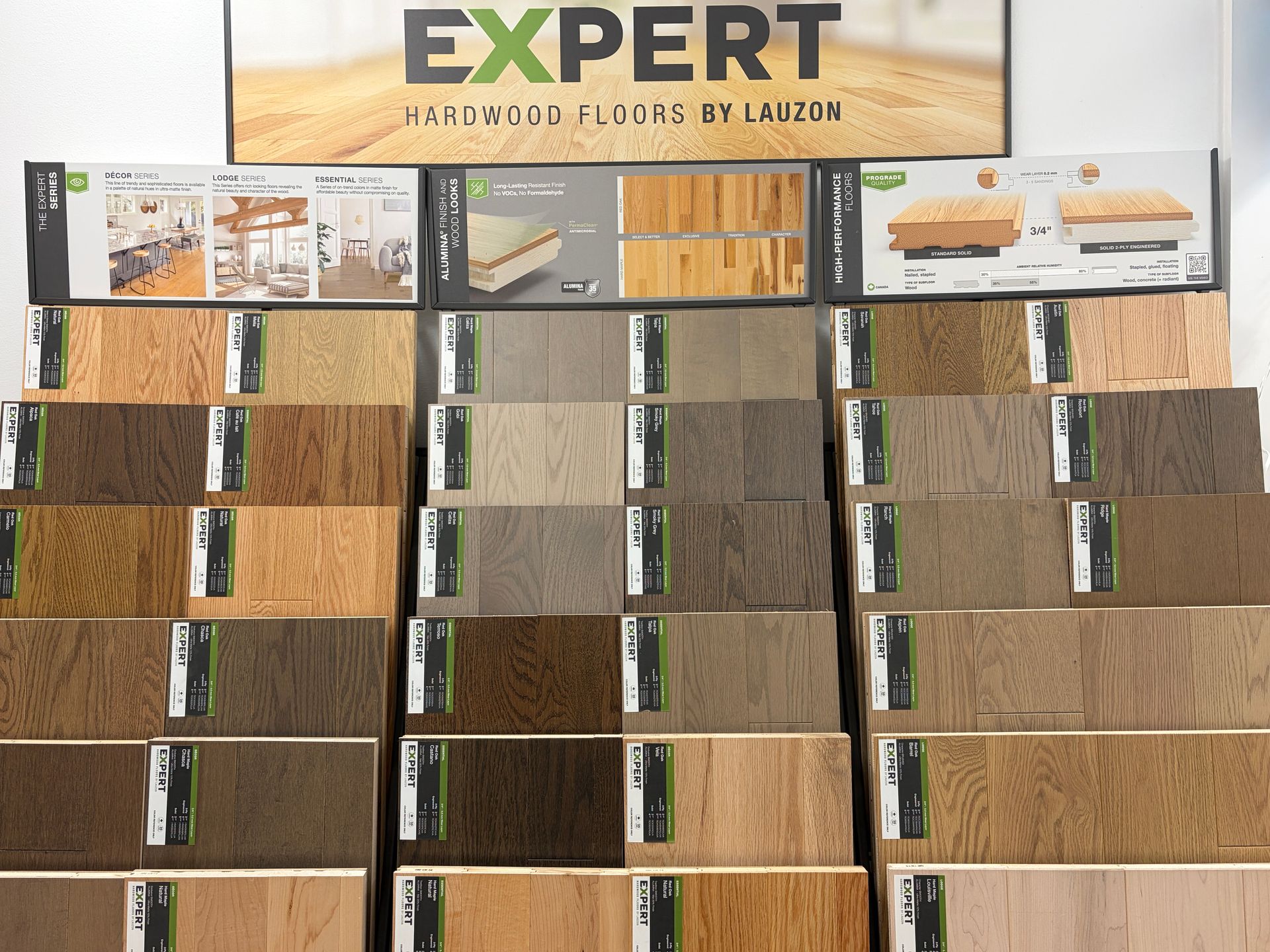 Display of various hardwood floor samples in different colors at a store.