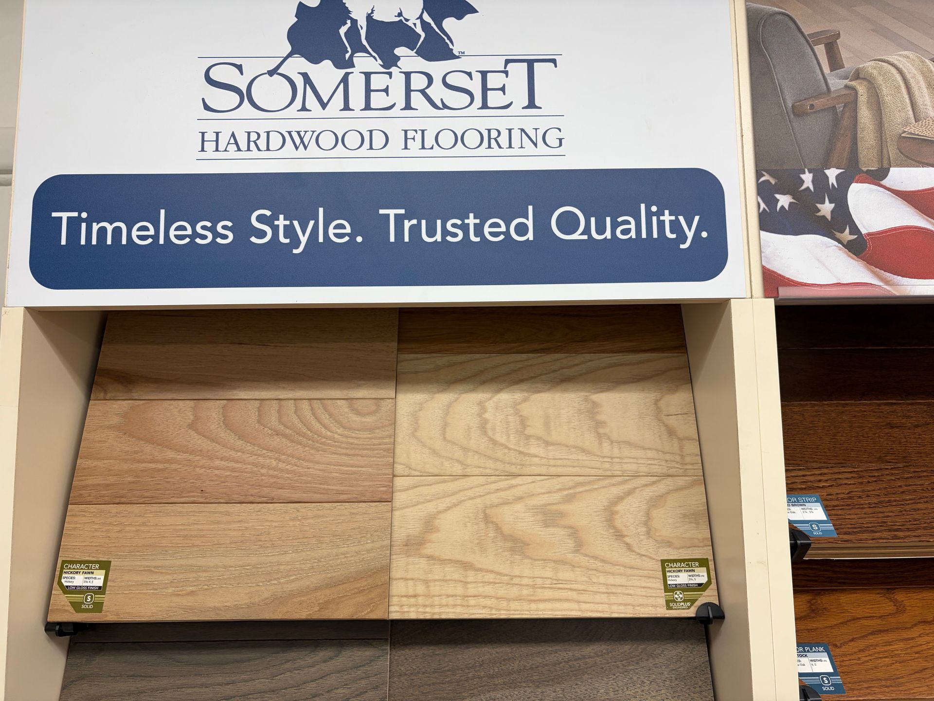 Close-up of wood flooring samples in various shades of brown and tan, labeled 