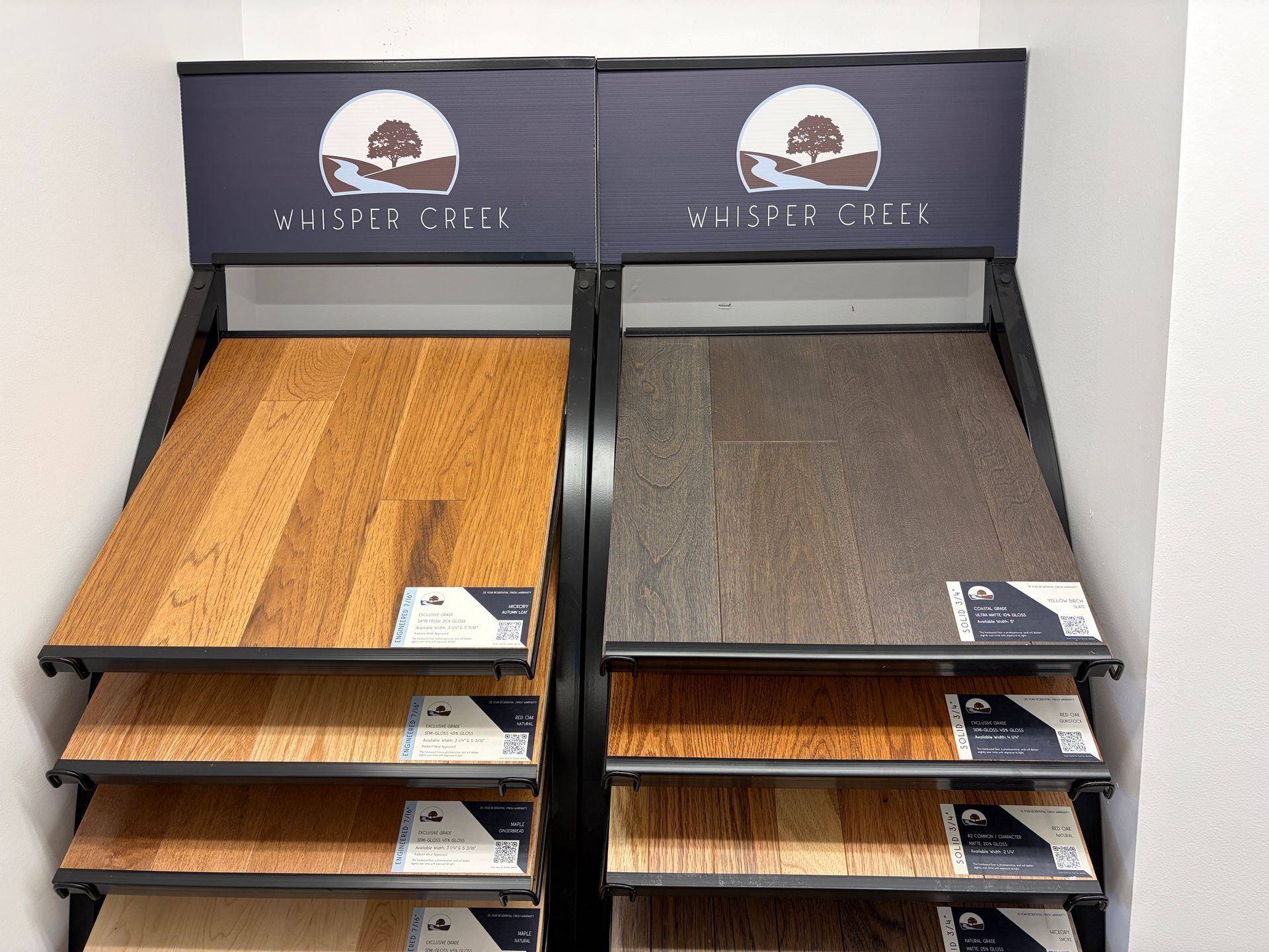 Wooden flooring samples in a display rack, showing variations in color and grain.