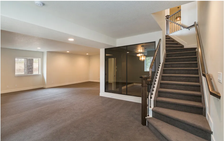 A white carpet living room with a dog greeting its owner at the door