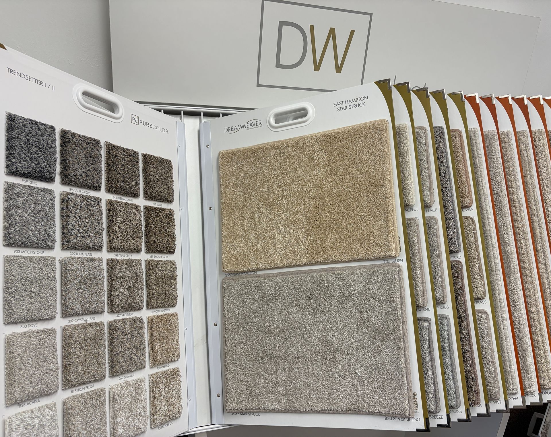 Carpet samples displayed in a showroom, showcasing various colors and textures for flooring options.