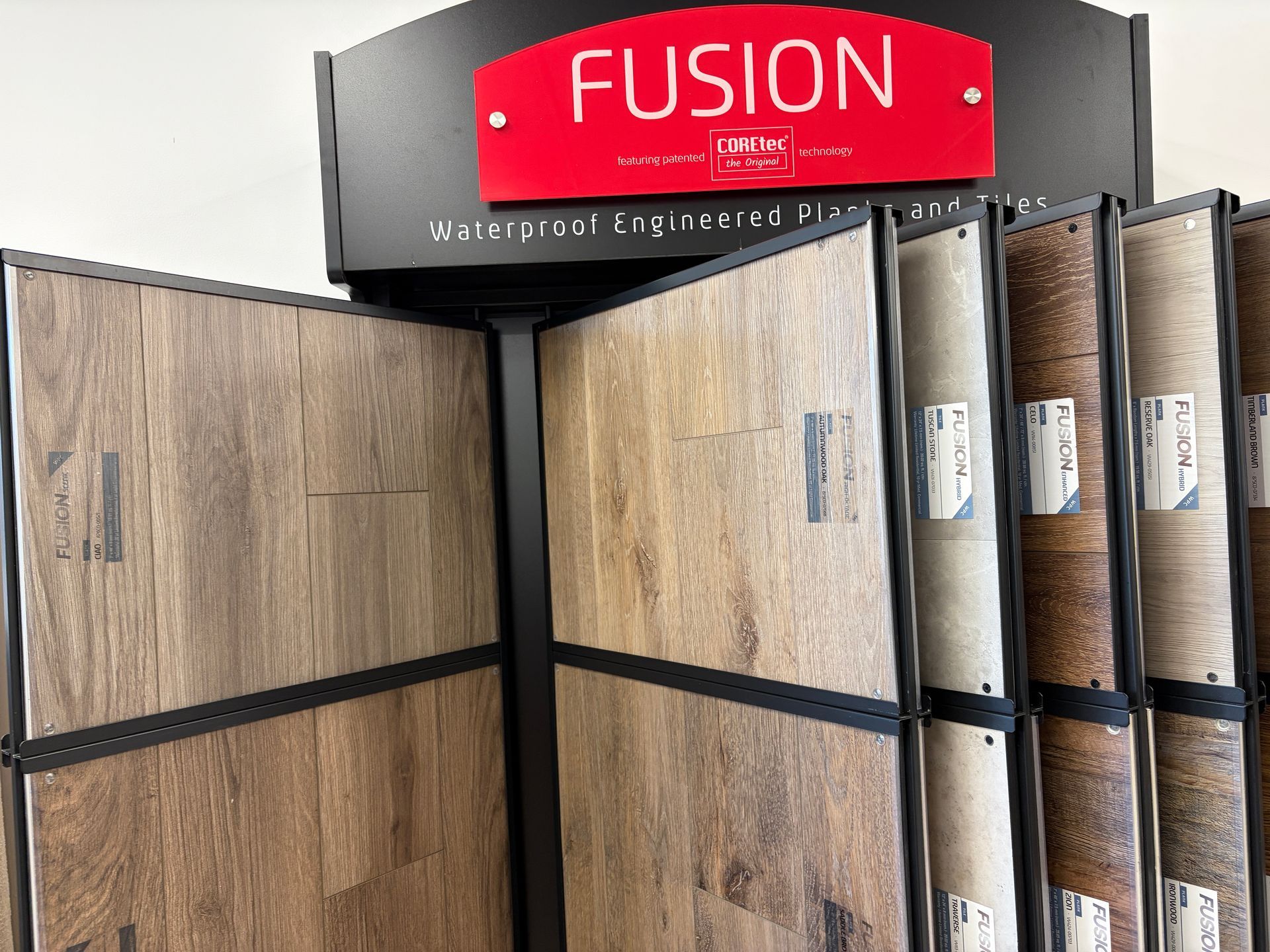 Display of various wood-look flooring samples under a 