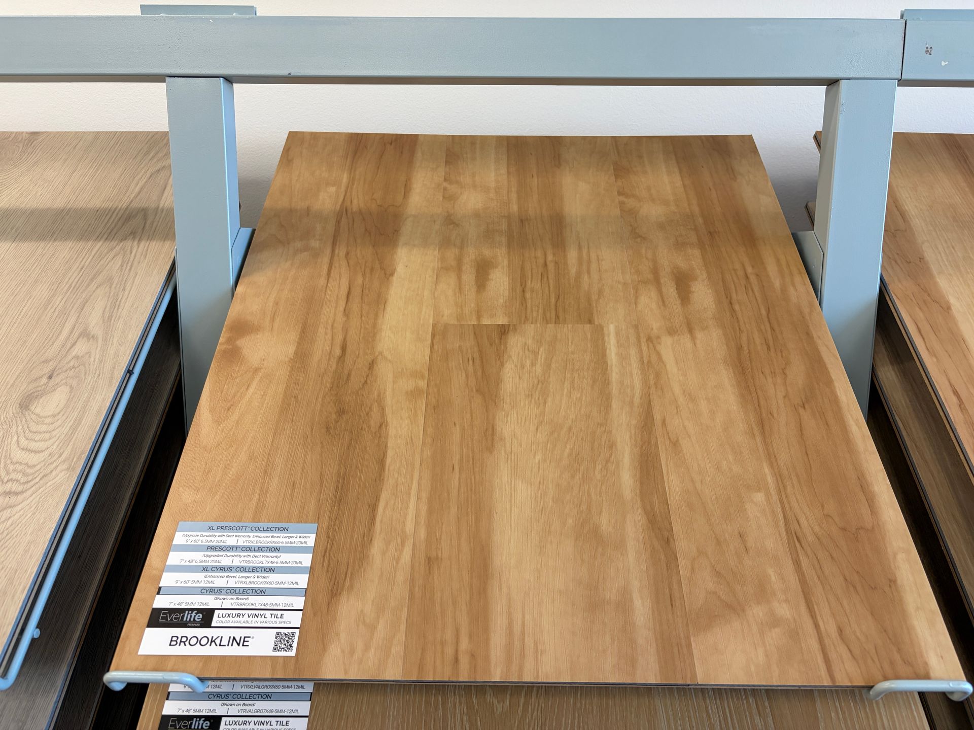 Display of wood flooring samples on metal racks.